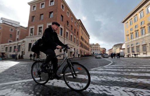 Cardinal Philippe Barbarin of Lyon, France, rides his bicycle as he arrives for the general congregation meetings in the synod hall at the Vatican March 11. The world's cardinals will enter the conclave March 12 to elect the new pope. (CNS photo/Eric Gaillard, Reuters) (March 11, 2025)