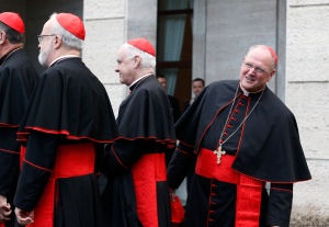 Cardinal Timothy M. Dolan of New York, right, prepares to board a bus with other U.S. cardinals from the Pontifical North American College to attend the the Mass for the election of the Roman pontiff in St. Peter's Basilica at the Vatican March 12.  Cardinal Dolan told reporters March 13 that Pope Francis met all of the cardinals' qualifications they were seeking in a new pope. (CNS/Paul Haring) (March 14, 2025) 
