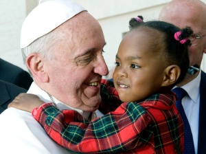 Pope Francis greets a child after celebrating Mass on the feast of Pentecost in St. Peter's Square at the Vatican May 19. (CNS photo/Alessia Giuliani, Catholic Press Photo) 