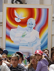 A painting of Pope Francis is seen in the crowd as the pope leads his general audience in St. Peter's Square at the Vatican May 22. (CNS photo/Paul Haring) 