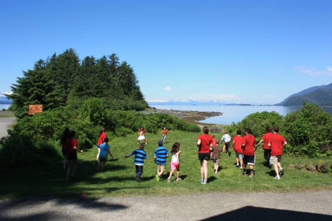 Campers and counselors head outdoors for a game.