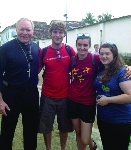Bishop Edward Burns, Carl Uchytil, Julia Smith, and Lindsey Jobbins of the Diocese of Juneau explore Paraty—a preserved Portuguese colonial town—near Rio de Janeiro during the World Youth Day pilgrimage. 