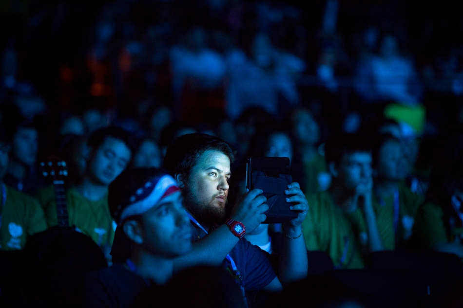 Jake Coffman, 23, a World Youth Day pilgrim from Juneau, Alaska, checks his electronic device during a lecture at the Rio Vivo Welcome Center in Rio de Janeiro July 24. (CNS photo/Tyler Orsburn) 
