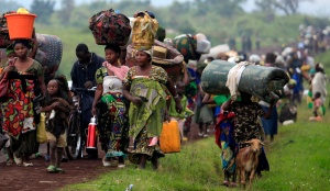 Families fleeing renewed fighting between the Democratic Republic of the Congo army and rebels walk toward the eastern city of Goma July 24. Congolese rebels and government forces traded heavy weapons fire around two eastern villages, forcing thousands of civilians to flee towards the provincial capital days ahead of a regional summit called to address the rebellion. (CNS photo/James Akena, Reuters)