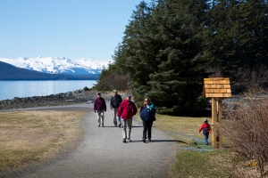 Visitors walk along causeway after visiting chapel on Shrine Island at Shrine of St. Therese in Juneau, Alaska
