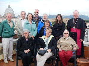 Partners in Faith pilgrims gather on the rooftop of the North American College in Rome: (top row, l-r) Terry Thompson, Mark Scheibe, Margaret Scheibe, Joe Robidou, Fr. Pat Travers, Deb Riva, Bishop Edward Burns. (Front row, l-r) Peggy Mattson, Janis Burns-Buyarski, Carolyn Thompson, and Eileen Casey.  