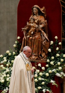 Pope Francis walks past a statue of Mary and the child Jesus during a prayer service New Year's Eve in St. Peter's Basilica at the Vatican. (CNS photo/Paul Haring) 