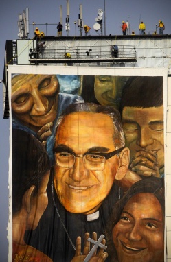 Workers hang image of Archbishop Oscar Romero near the Divine Savior of the World square in San Salvador for his May 23 beatification Mass. (CNS photo/Oscar Rivera, EPA) See ROMERO-BEATIFY May 23, 2015.