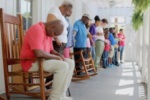 Members of the Manna Life Center lead an ecumenical prayer service June 19 at the Neighborhood House in Charleston, S.C., which is part of Our Lady of Mercy Community Outreach Center. They prayed for the victims of the shootings at Emanuel African Methodist Episcopal Church, and the children who lost their parents. (CNS photo/Victoria Wain,The Catholic Miscellany) See TRAGEDY-SHOOTING (UPDATED) June 19, 2015, and story to come.