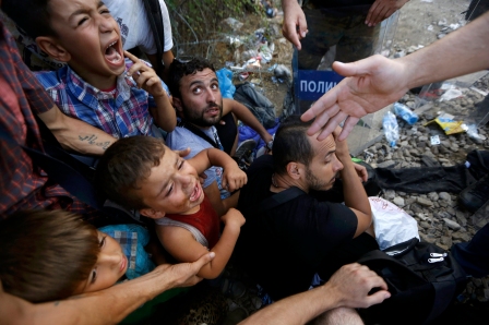 Syrian refugee children scream as they sit in front of Macedonian riot police at the Greek-Macedonian border, near the village of Idomeni, Greece, Aug. 21. Pope Francis referred to the plight of persecuted Christians during his Aug. 30 audience address. (CNS photo/Yannis Behrakis, Reuters) See AUSTRIA-MIGRANTS-TRUCK and POPE-PERSECUTION Aug. 31, 2015.