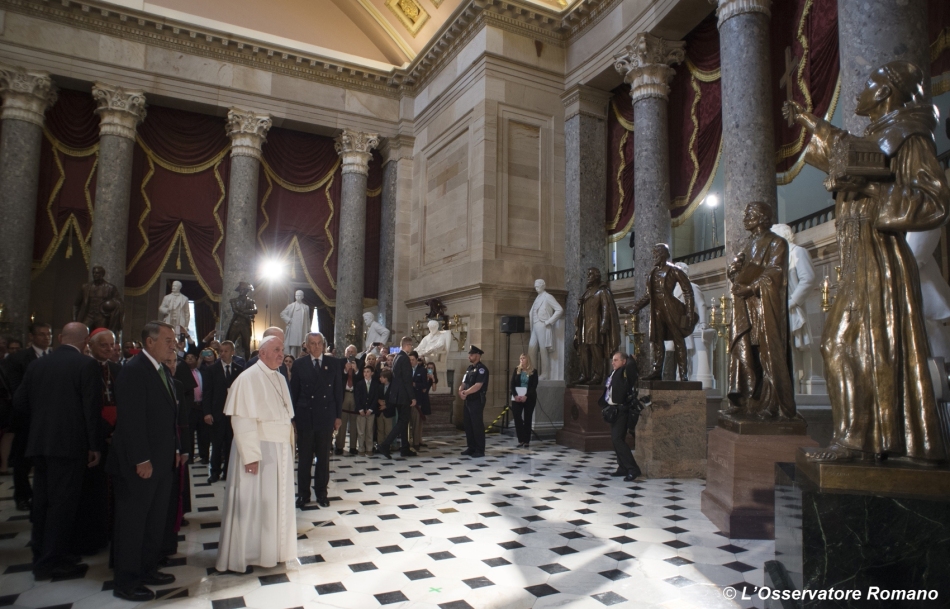 Pope Francis pauses in front of a statue of St. Junipero Serra in National Statuary Hall in the U.S. Capitol in Washington Sept. 24. Standing next to the pope is John Boehner, speaker of the United States House of Representatives. (CNS photo/L'Osservatore Romano, handout) 