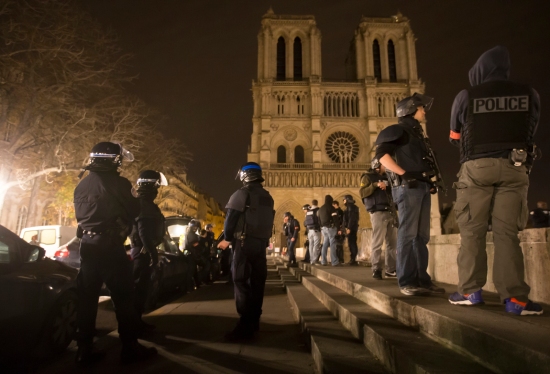 Armed police officers go on foot patrol around Notre Dame Cathedral in Paris Nov. 14. Dozens of people were killed in a series of attacks in Paris Nov. 13. (CNS photo/Ian Langsdon, EPA) 