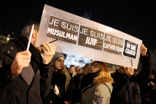 People hold a placard that reads "I am Muslim, I am Jewish, I am Catholic, I am Charlie" during a Jan. 8 vigil in Paris, following the mass shooting at the offices of Charlie Hebdo, a satirical newspaper in Paris. Pope Francis condemned the killings of at least 12 people at the offices of the publication Jan. 7 and denounced all "physical and moral" obstacles to the peaceful coexistence of nations, religions and cultures. (CNS photo/Jacky Naegelen, Reuters)